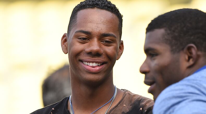 Hunter Greene talks with Dodgers right fielder Yasiel Puig during batting practice before a game against the Phillies at Dodger Stadium on April 28.