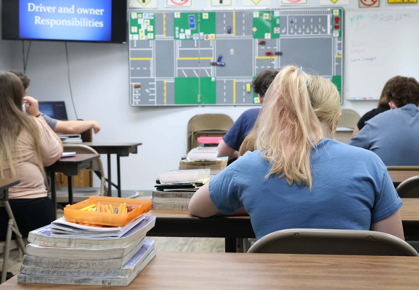 Students prepare for a class at D&D Driving School in Kettering on Wednesday, Aug. 6. A forthcoming change to Ohio law that will force more drivers in training to get a formal education is expected to bring more business to driver schools. BRYANT BILLING / STAFF
