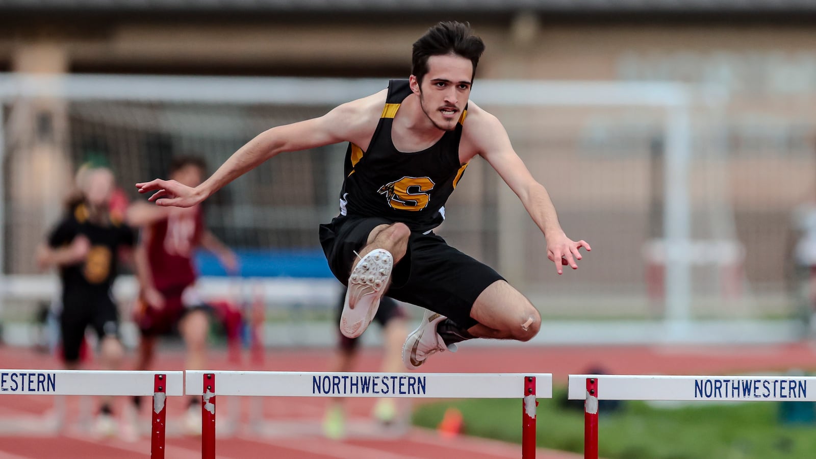 Shawnee High School's Logan Smith competes in the 300 meter hurdles event at the Clark County Track and Field Championships on Monday, May 5 at Northwestern High School. MICHAEL COOPER/STAFF