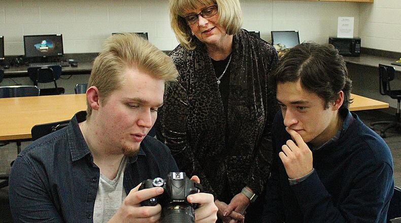 Northwestern High School students (left) Justin Adamson and Devin Chen and Video Production II teacher, Lisa Boggess helped produce an award winning anti bulling video. JEFF GUERINI/STAFF