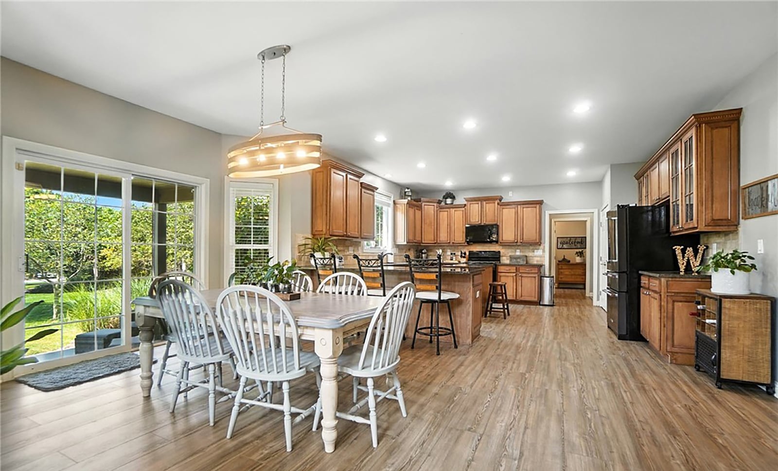 The eat in kitchen has wood cabinets with tile backsplash and granite tops, a breakfast bar, island and planning desk. There is also a butler's pantry, LVT flooring and a dining area with chandelier. CONTRIBUTED