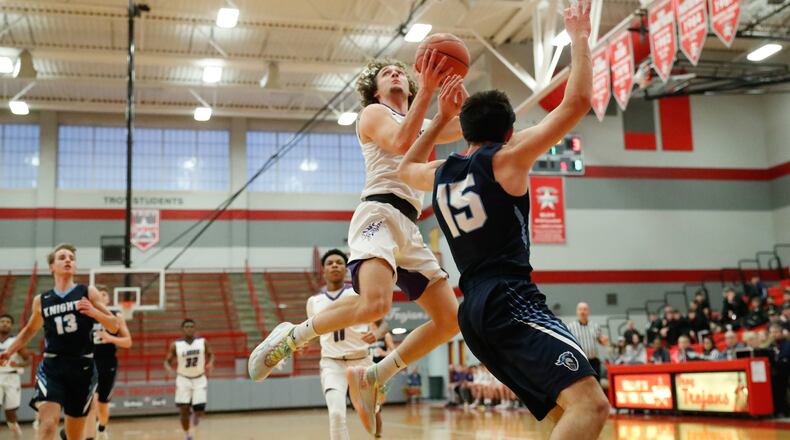 Emmanuel Christian Academy senior Casey Swank drives to the hoop during their Division IV sectional game on Tuesday night at Troy High School. CONTRIBUTED PHOTO BY MICHAEL COOPER