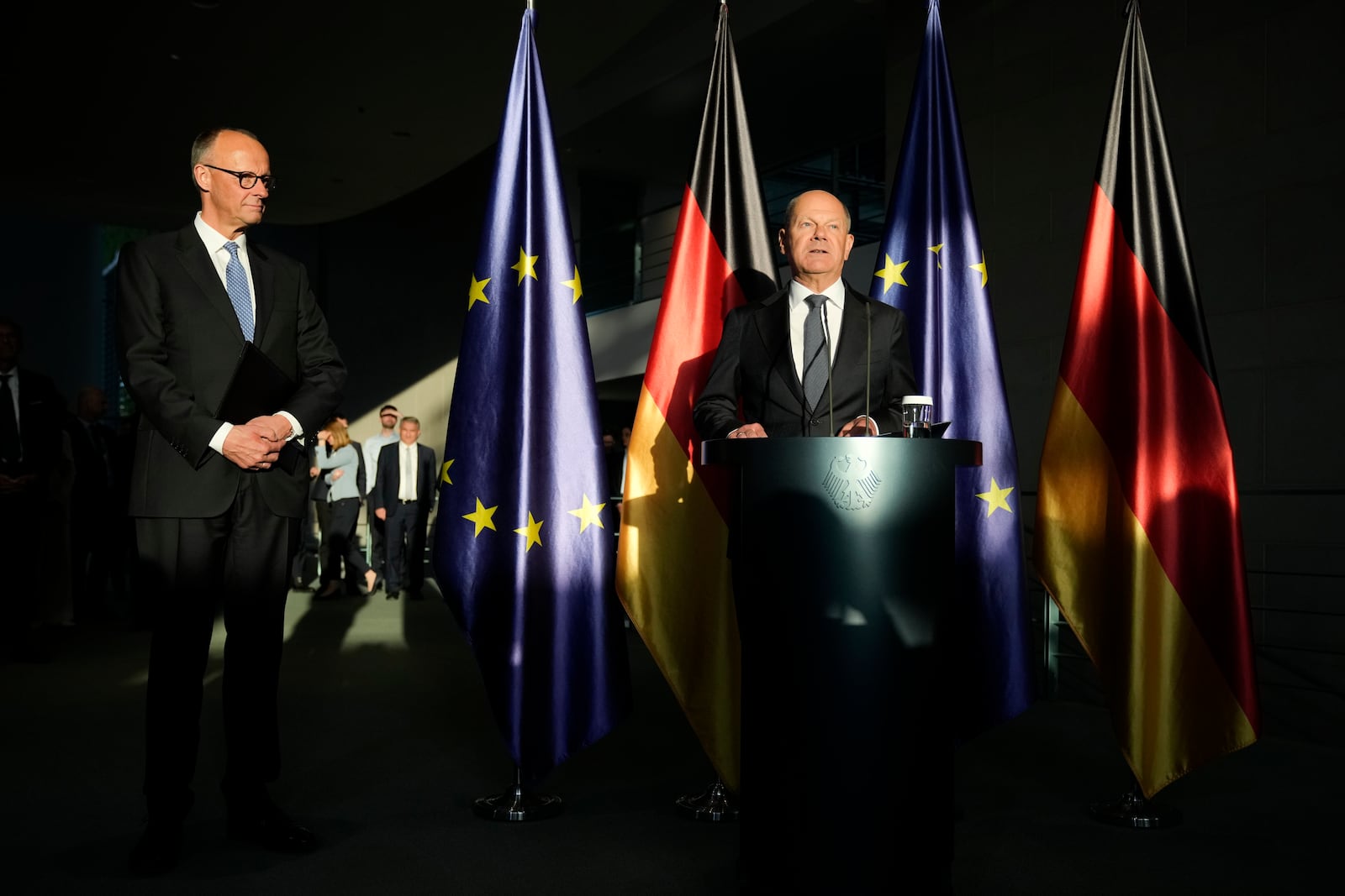 New elected German Chancellor Friedrich Merz, left, and former Chancellor Olaf Scholz, right, attend a handover ceremony in the chancellery in Berlin, Tuesday, May 6, 2025. (AP Photo/Ebrahim Noroozi)