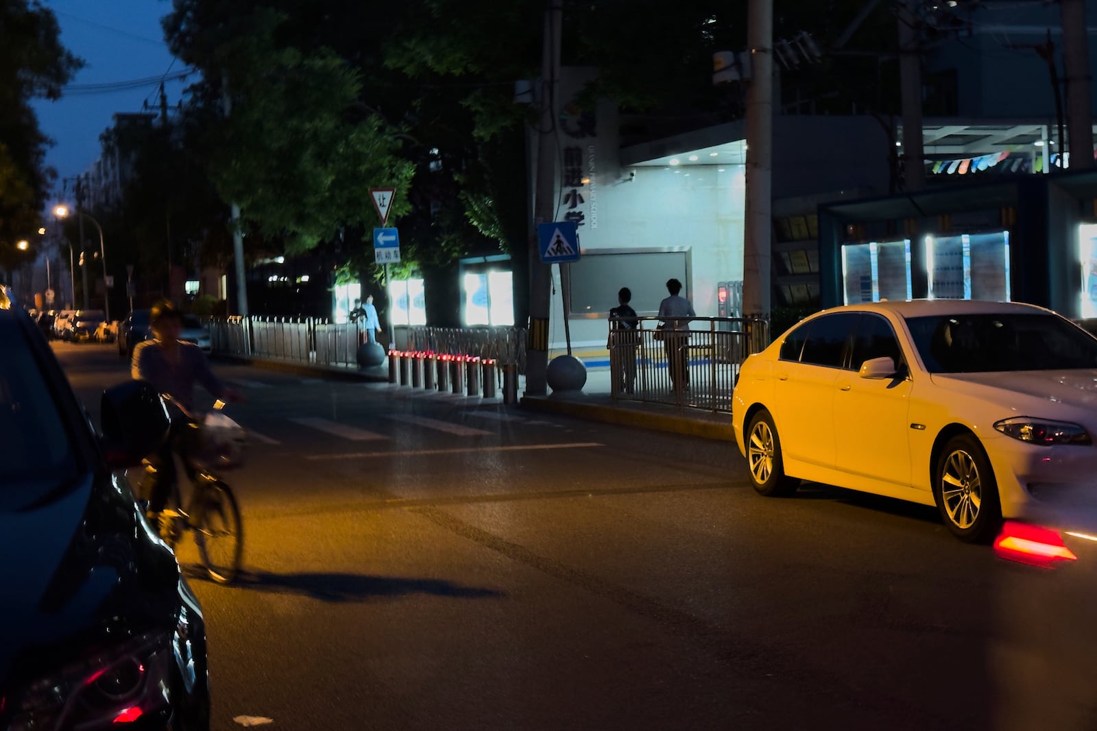 Residents pass by an entrance gate of Qianjin primary school after a driver hit and injured several pedestrians outside the school in the northwestern Haidian district, in Beijing on May 15, 2025. (AP Photo/Andy Wong)