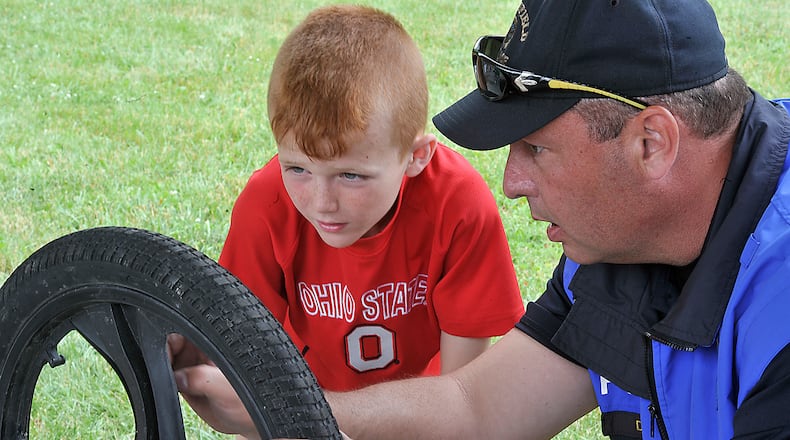 Children from ages 7-15 participate in the Springfield Police Division's 18th annual Summer Bike Camp Monday. The two week-long camp sessions start with police officers teaching bicycle safety and performing bike inspections and maintenance. Later in the week, the officers and campers will take daily bike trips on the trails throughout Clark County. Bill Lackey/Staff