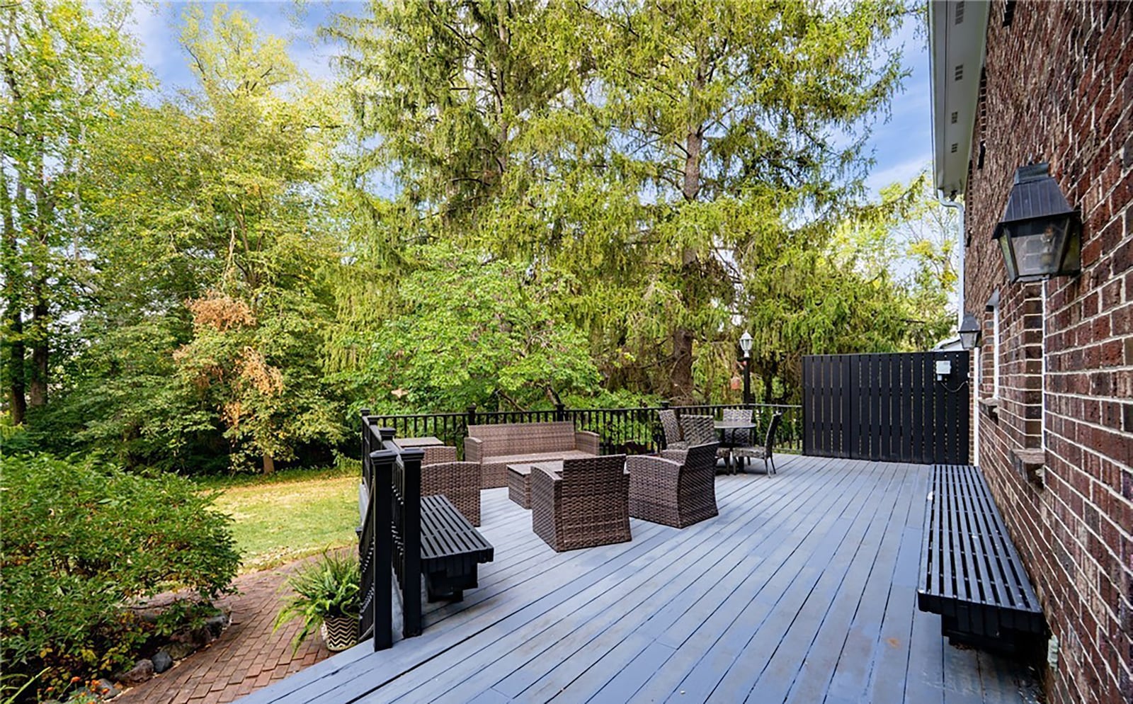 The wood deck has built in benches and railings. It over looks the wooded back yard. CONTRIBUTED