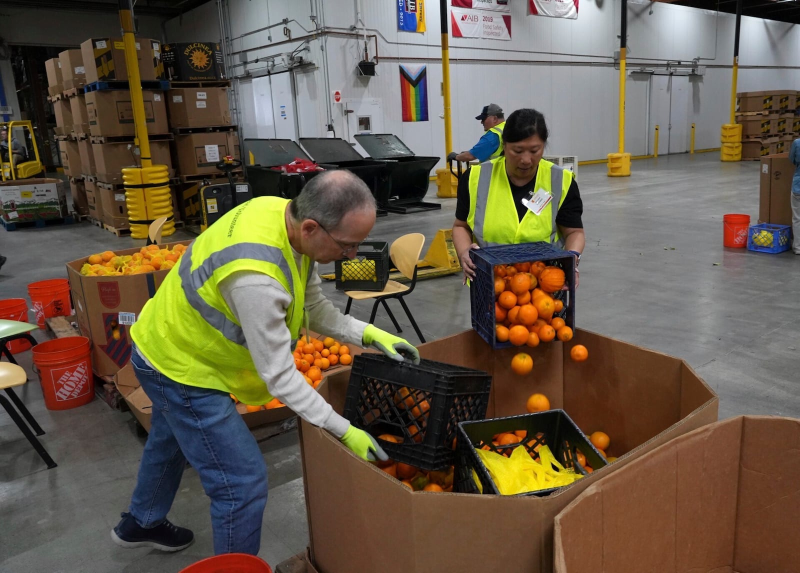 Volunteers pack produce at the Alameda County Community Food Bank in Alameda, Calif., on Friday, April 25, 2025. (AP Photo/Terry Chea)
