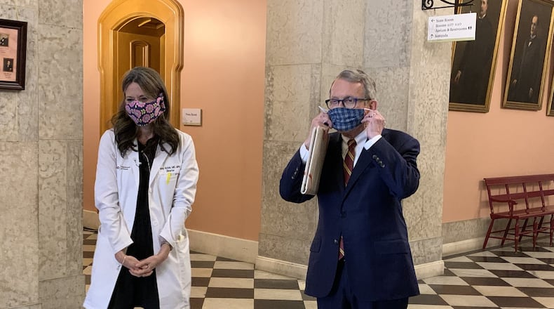 Ohio Gov. Mike DeWine and Ohio Department of Health Director Amy Acton wear homemade masks when in public places.