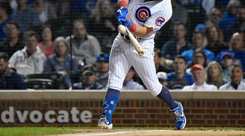 CHICAGO, ILLINOIS - SEPTEMBER 16: Kyle Schwarber #12 of the Chicago Cubs hits a three run home run in the first inning against the Cincinnati Reds at Wrigley Field on September 16, 2019 in Chicago, Illinois. (Photo by Quinn Harris/Getty Images)