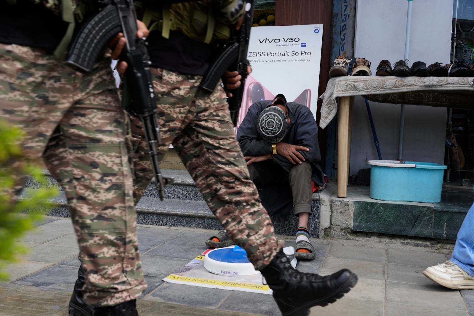Indian soldiers patrol as a street vendor takes a nap after India and Pakistan reported no incidents of firing overnight, in Srinagar, Indian controlled Kashmir Monday, May 12, 2025. (AP Photo/Mukhtar Khan)
