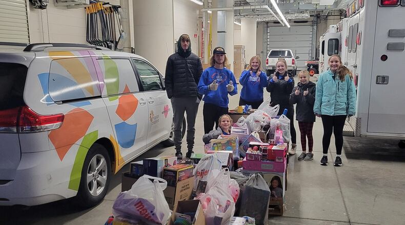 The Clark and Fitzsimmons family and friends deliver toys to the Ronald McDonald House and Dayton Children's Hospital on December 19. CONTRIBUTED