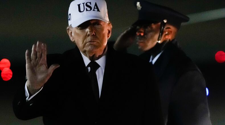 President Donald Trump waves after arriving on Air Force One from Florida, Sunday, Jan. 11, 2026, at Joint Base Andrews, Md. (AP Photo/Julia Demaree Nikhinson)