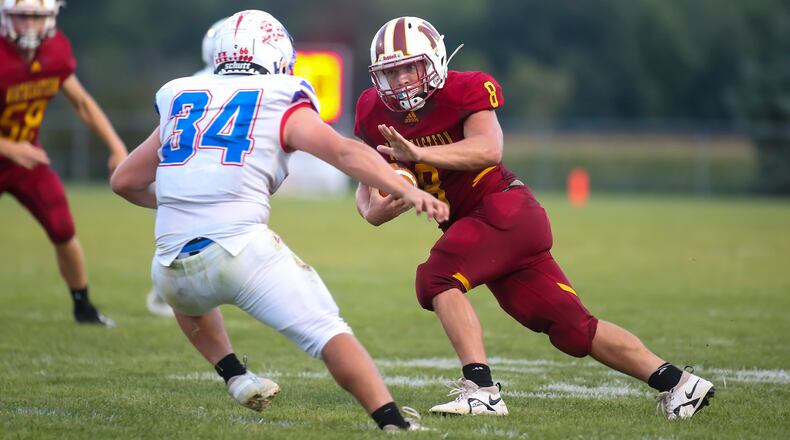 Northeastern High School junior Hunter Albright tries to stiff arm Greeneview's Jarrod Mays during their game against Greeneview on earlier this season at Conover Field in Springfield. CONTRIBUTED PHOTO BY MICHAEL COOPER