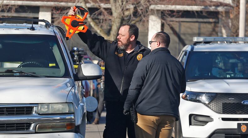 The Springfield Police Division investigate Chevy Tahoe, parked along Mason Street, where a man was found with a suspected gunshot wound to the head Tuesday, Feb. 6, 2024. BILL LACKEY/STAFF