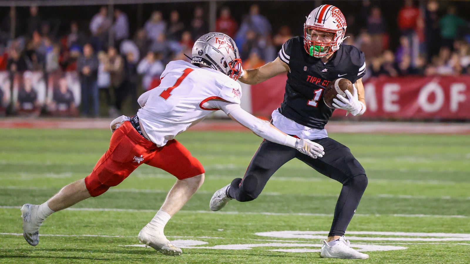 Tippecanoe senior receiver Will Strong runs with pressure from Troy's Aidan Gorman during the third quarter of a Miami Valley League game on Friday in Tipp City Park. BRYANT BILLING / STAFF