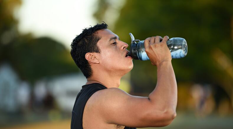 Drinking water or a sports drink should go hand in hand with exercise in the heat. CONTRIBUTED