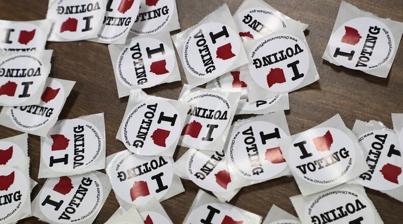 “I Love Voting” stickers wait for voters as they exit a Springfield election poll Tuesday. BILL LACKEY/STAFF