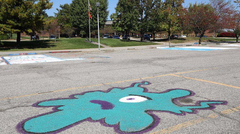 A student's parking spot painting seems a little ironic in the empty parking lot of Kenton Ridge. The school had an outbreak of COVID-19 cases and went to online learning for two weeks. Northeastern schools will now use hybrid learning through next week due to Clark County coronavirus alert level. BILL LACKEY/STAFF