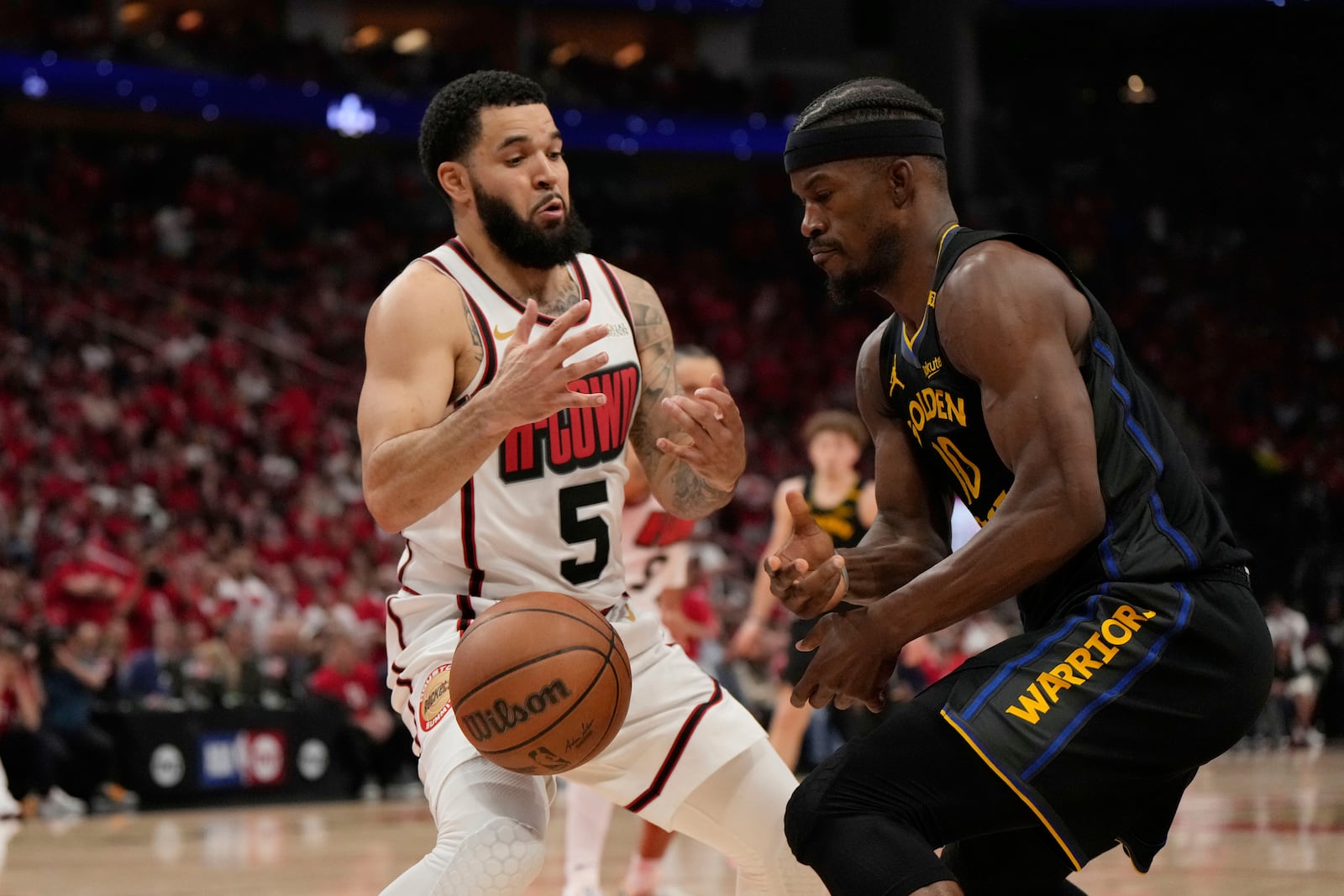 Golden State Warriors' Jimmy Butler III (10) loses the ball as Houston Rockets' Fred VanVleet (5) defends during the second half of Game 7 of an NBA basketball first-round playoff series Sunday, May 4, 2025, in Houston. (AP Photo/Ashley Landis)
