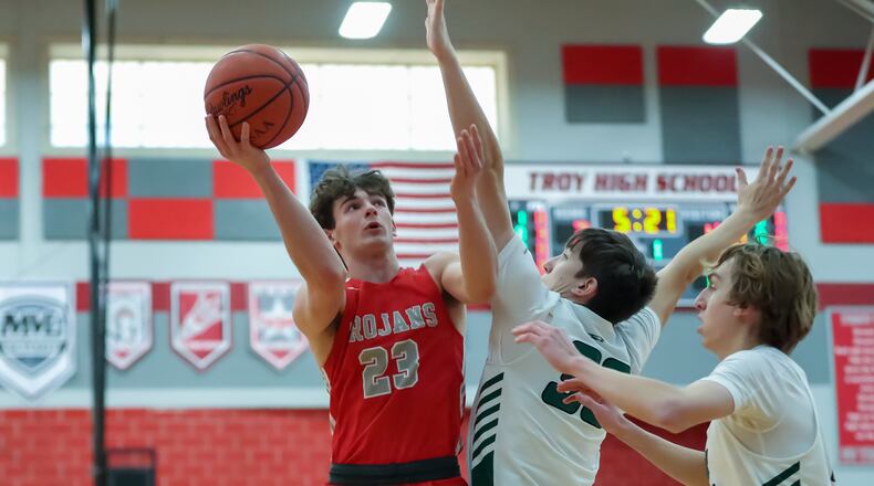 Southeastern High School sophomore Ayden Robinson drives to the basket against Troy Christian junior Frank Rupnik during their game on Friday night at Troy High School. The Eagles won 61-51. CONTRIBUTED PHOTO BY MICHAEL COOPER