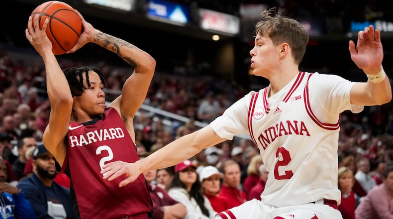 FILE - Harvard guard Malik Mack, left, looks to pass the ball around Indiana guard Gabe Cupps, right, in the first half of an NCAA college basketball game in Indianapolis, Nov. 26, 2023. (AP Photo/AJ Mast, File)
