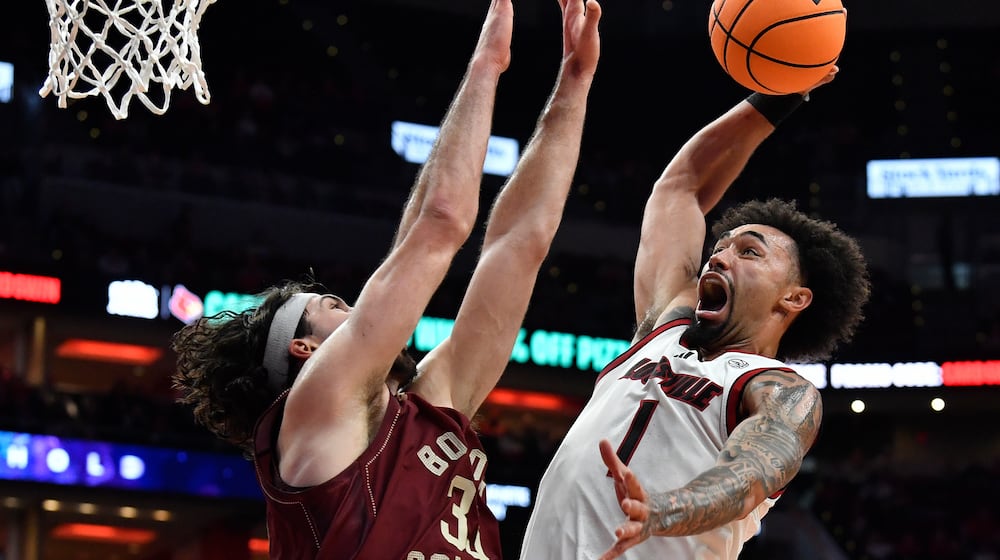 Louisville guard J'vonne Hadley (1) goes in for a dunk against Boston College center Boden Kapke (33) during the second half of an NCAA college basketball game in Louisville, Ky., Saturday, Jan. 10, 2026. (AP Photo/Timothy D. Easley)