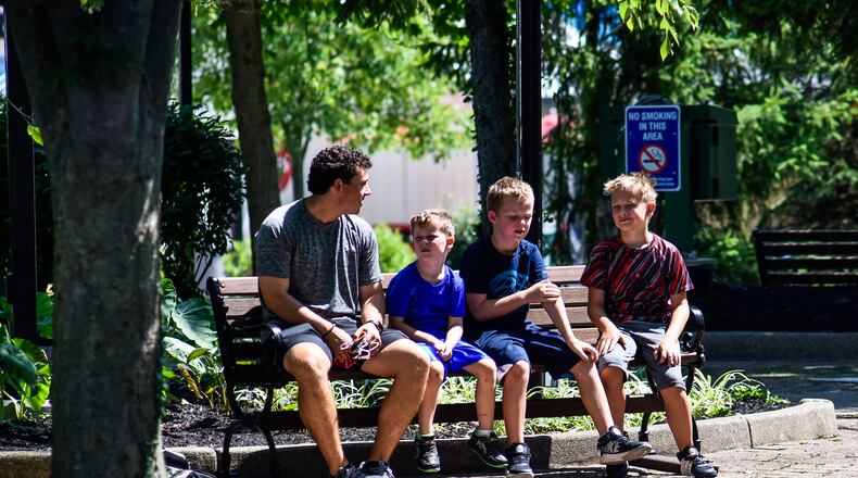 Kings Island opens to pass holders July 2 with numerous protocols in place to decrease the chance of spread of COVID-19. Guest must pre-register for admission to the park and are required to wear masks, get their temperature taken and stand in accordance with social distancing guidelines. There are also hundreds of hand sanitizers stations around the park and staff cleaning rides, games, restaurants and touch surfaces regularly. NICK GRAHAM / STAFF
