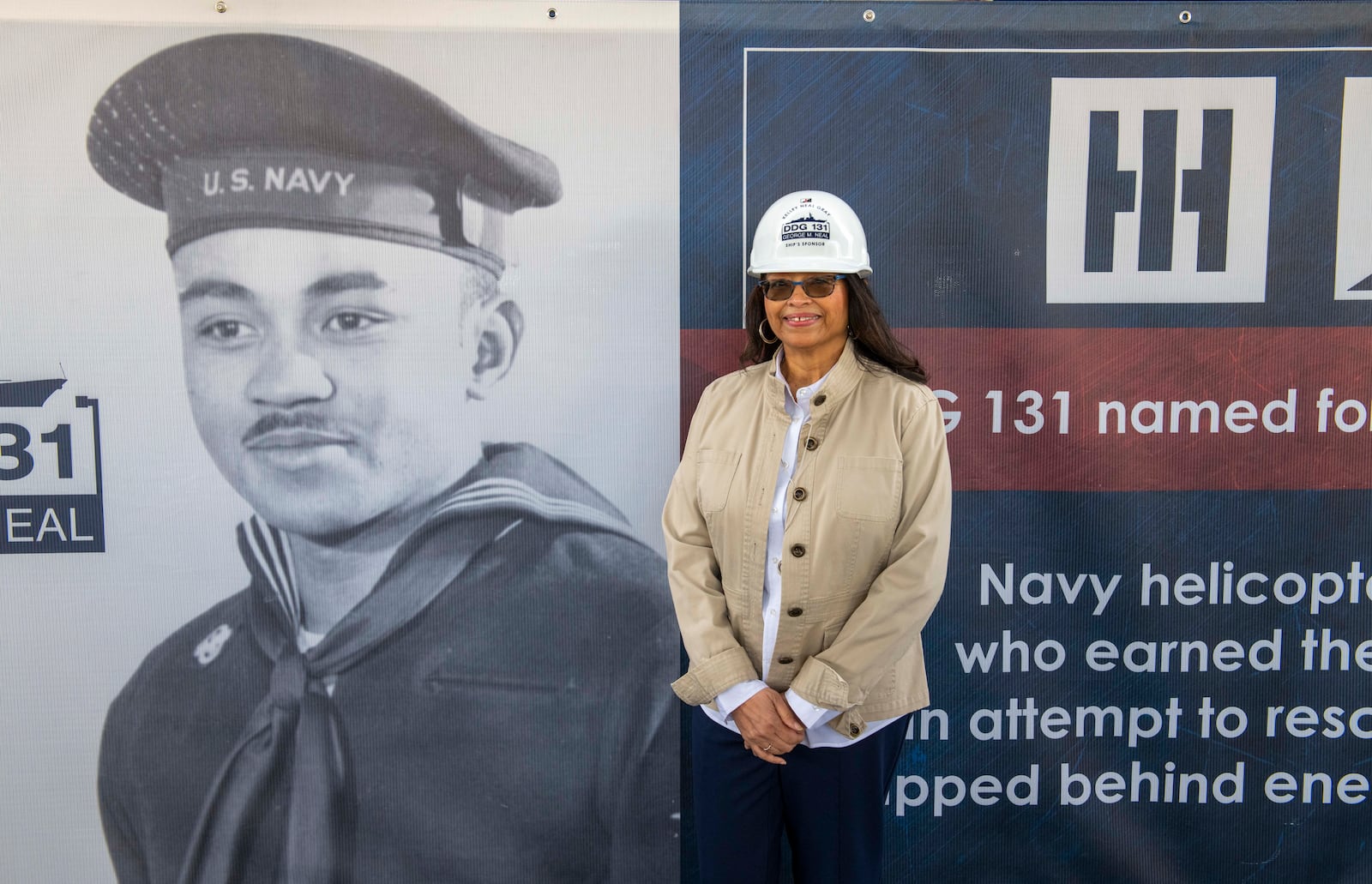 Kelley Elaine Neal Gray next to a picture of her late father at the Dec. 15 keel authentication ceremony for the Navy battleship that will be named for him. CONTRIBUTED