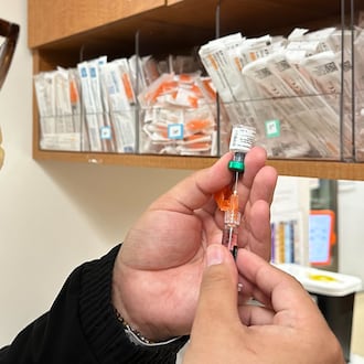 Licensed practical nurse Marco Flores prepares a patient's measles, mumps and rubella vaccine at Children's Minnesota on Nov. 20, 2025, in Minneapolis. (AP Photo/Devi Shastri)