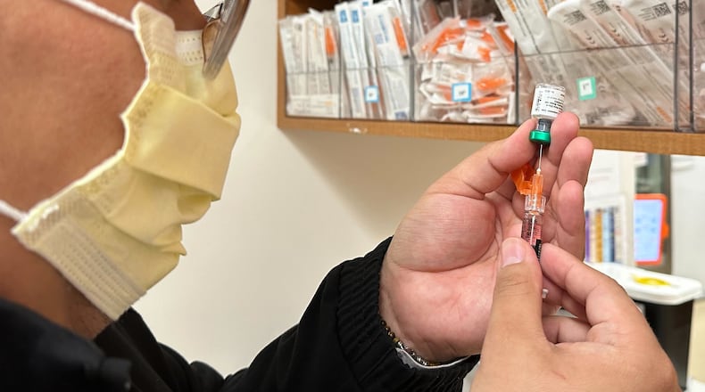 Licensed practical nurse Marco Flores prepares a patient's measles, mumps and rubella vaccine at Children's Minnesota on Nov. 20, 2025, in Minneapolis. (AP Photo/Devi Shastri)