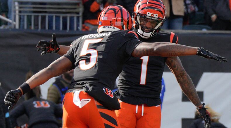 Cincinnati Bengals wide receiver Tee Higgins (5) celebrates with wide receiver Ja'Marr Chase (1) after making a touchdown catch during the first half of an NFL football game, Sunday, Dec. 22, 2024, in Cincinnati. (AP Photo/Jeff Dean)