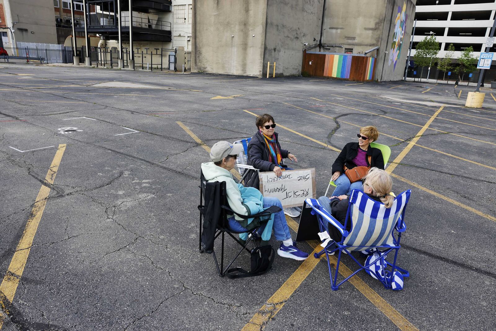 A group from Liberal Coffee Club sits in the protest zone of the NATO Parliamentary Assembly in downtown Dayton, Friday, May 23, 2025. NICK GRAHAM/STAFF