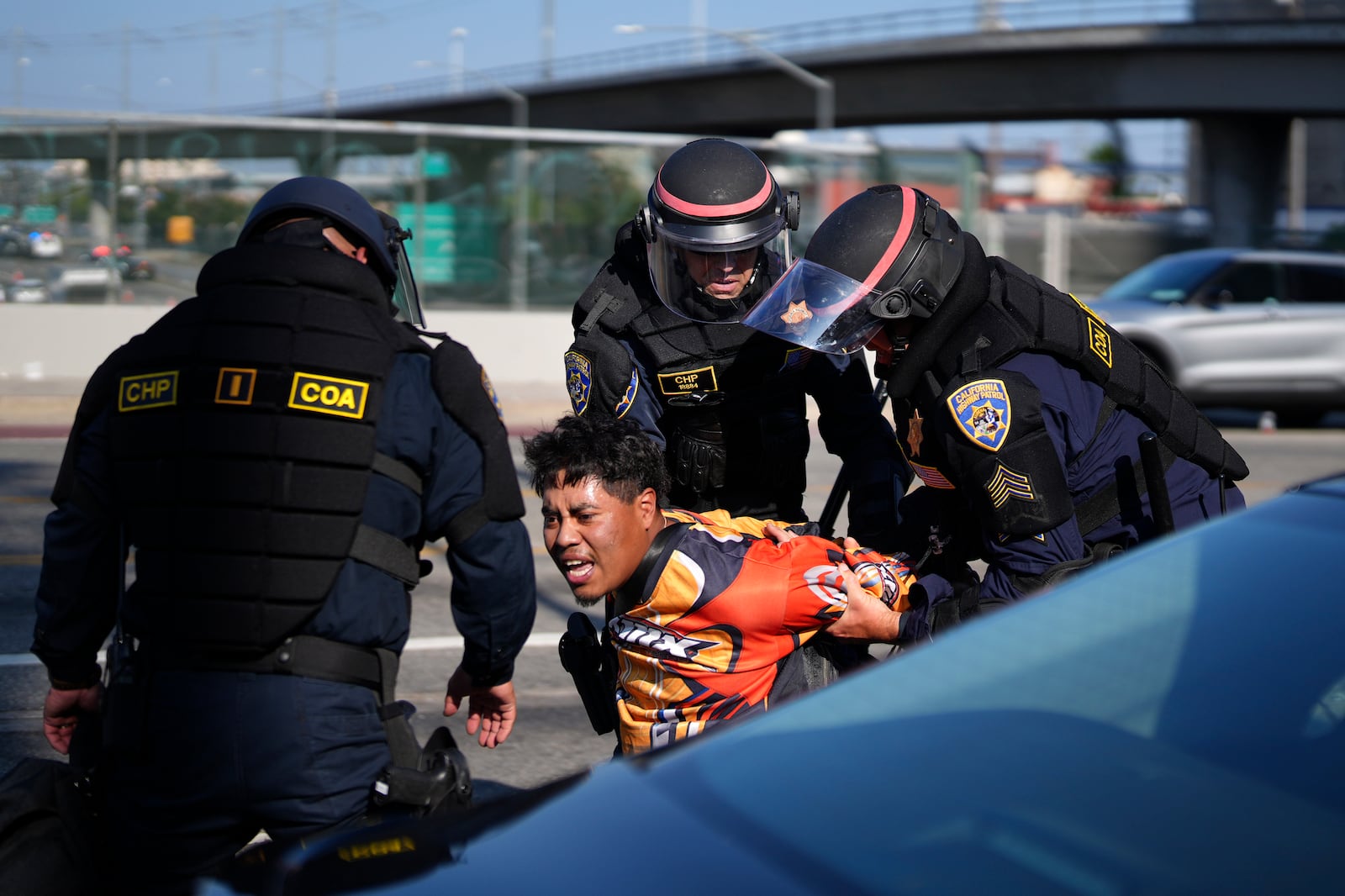 A protester is arrested by California Highway Patrol near the federal building in downtown Los Angeles on Tuesday, June 10, 2025. (AP Photo/Eric Thayer)