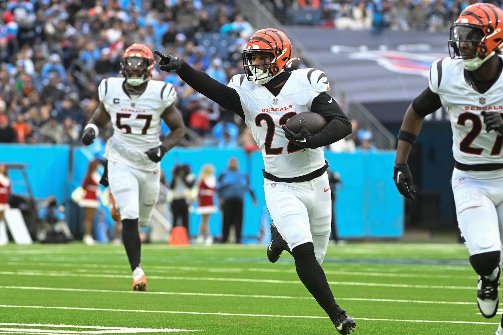 Cincinnati Bengals safety Geno Stone (22) points as he runs towards the endzone to score a touchdown during the second half of an NFL football game against the Tennessee Titans, Sunday, Dec. 15, 2024, in Nashville, Tenn. (AP Photo/John Amis)