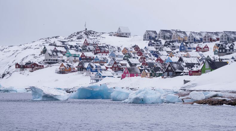 FILE - Coloured houses covered by snow are seen from the sea in Nuuk, Greenland, on March 6, 2025. (AP Photo/Evgeniy Maloletka, File)