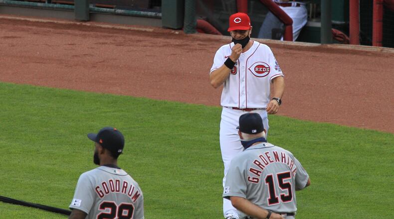 Cincinnati Reds manager David Bell pulls down his mask to say hi to Tigers manager Ron Gardenhire during pregame ceremonies on Opening Day on Friday, July 24, 2020, at Great American. Ball Park in Cincinnati. David Jablonski/Staff
