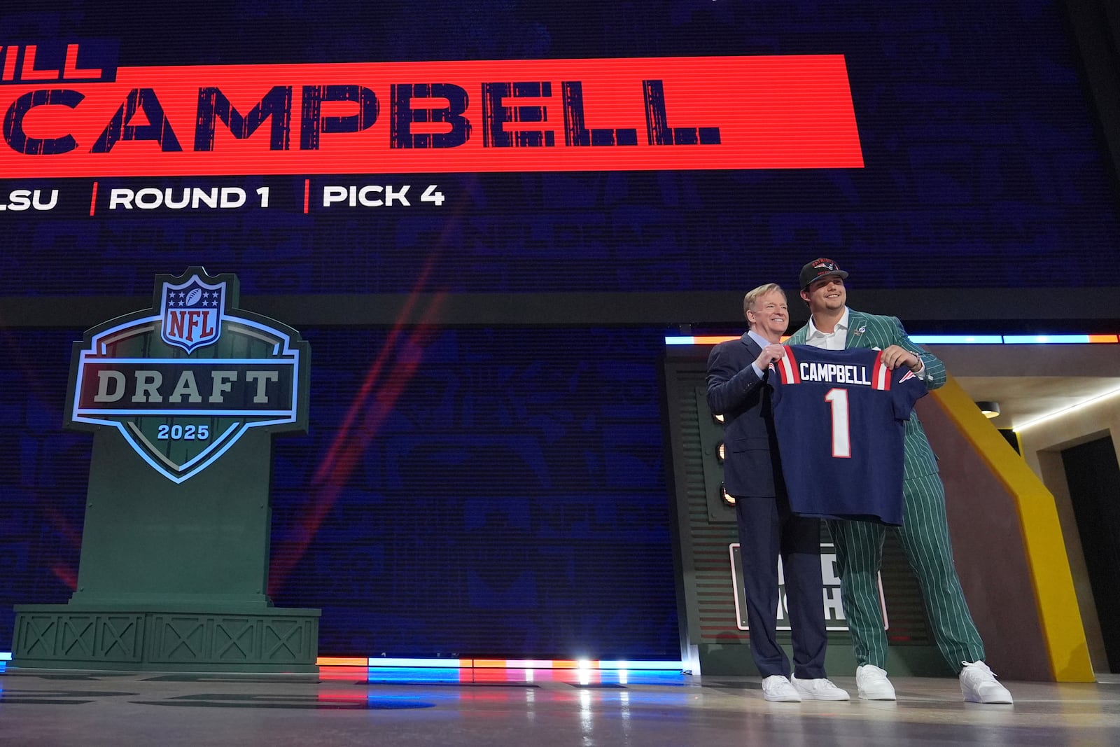 LSU offensive tackle Will Campbell, right, poses with NFL Commissioner Roger Goodell after being chosen by the New England Patriots with the fourth overall pick during the first round of the NFL football draft, Thursday, April 24, 2025, in Green Bay, Wis. (AP Photo/Jeff Roberson)