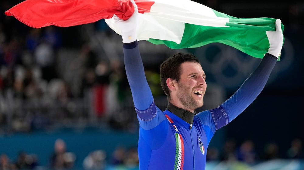 Team Italy's Michele Malfatti celebrates winning the gold medal in the final of the men's team pursuit speedskating race at the 2026 Winter Olympics, in Milan, Italy, Tuesday, Feb. 17, 2026. (AP Photo/Ben Curtis)