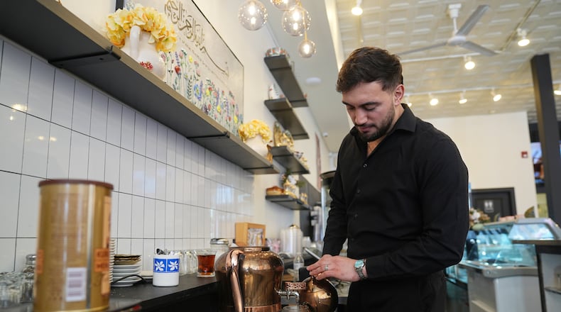 Muhammed Emanet pours Turkish tea for a guest at the Jersey Kebab restaurant, Thursday, Jan. 29, 2026, in Collingswood, N.J. (AP Photo/Matt Rourke)