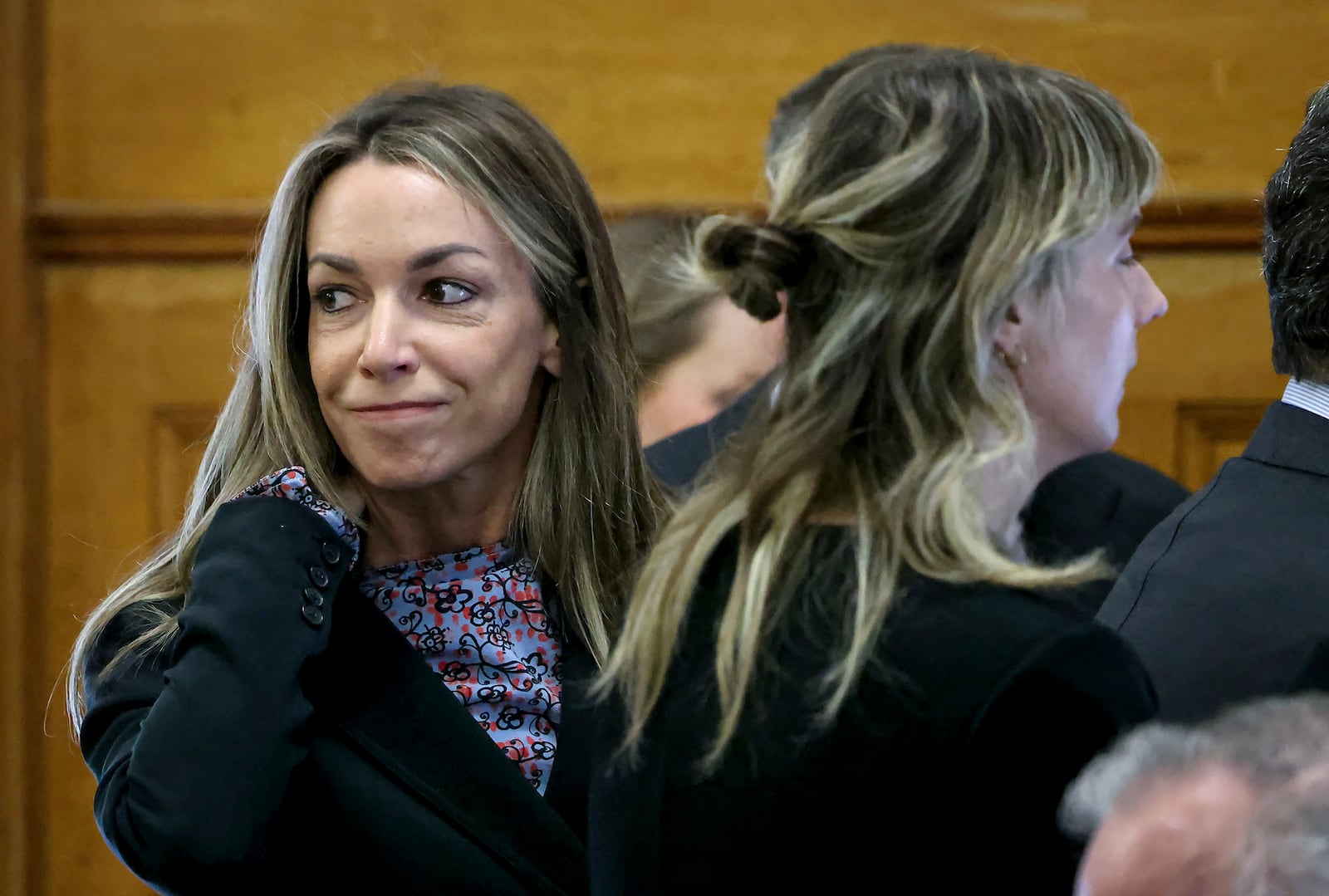 Defendant Karen Read smiles at her family before closing arguments during her murder trial in Norfolk Superior Court, Friday, June 13, 2025, in Dedham, Mass. (Mark Stockwell/The Sun Chronicle via AP, Pool) /// [EXTERNAL]