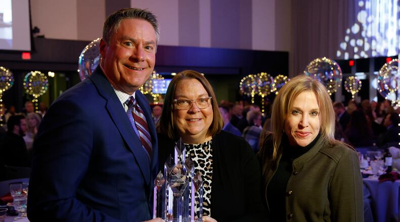 Mike McDorman, president and CEO of the Greater Springfield Partnership, and Clark State President Jo Alice Blondin present Alicia Sweet Hupp with the Richard L. Kuss Lifetime Community Achievement Award during the Partnership's annual meeting Thursday, Feb. 22, 2024 at the Hollenbeck Bayley Creative Arts & Conference Center. BILL LACKEY/STAFF
