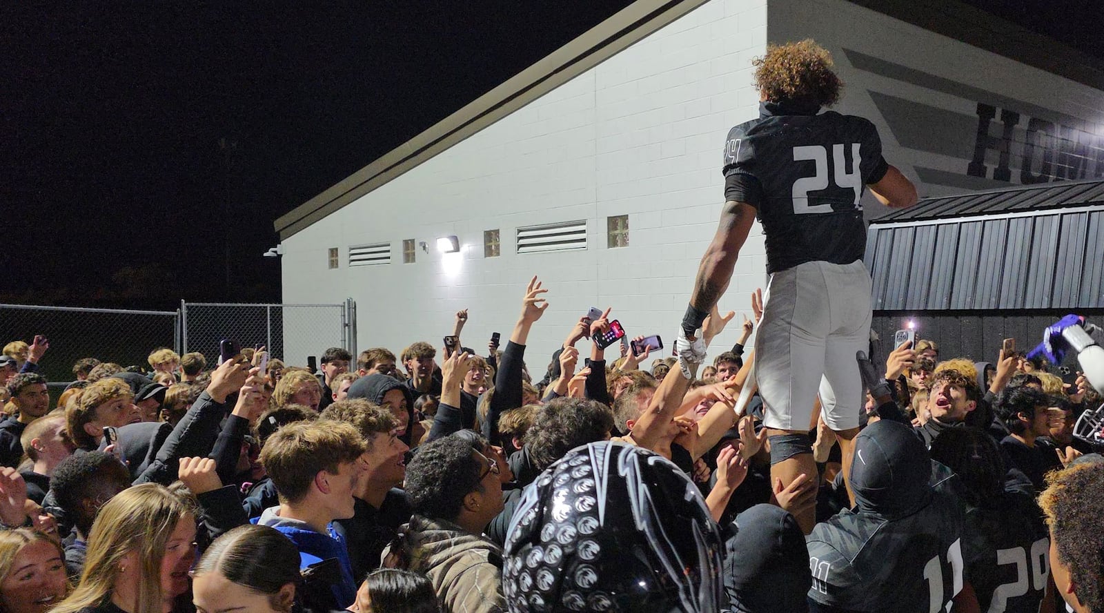 Lakota East's Ryder Hooks celebrates with fans after their football game against Lakota West Friday, Oct. 24, 2025 at Lakota East High School in Liberty Township. East won 42-28. NICK GRAHAM/STAFF