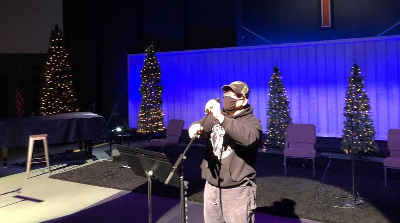 Jon Owings, technical coordinator at First Christian Church, makes adjustments in preparation for upcoming Christmas Eve Services. First Christian is one of several area churches that will offer multiple Christmas Eve services as well as livestreaming. Photo by Brett Turner