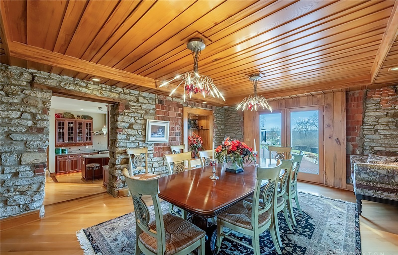 The dining room is original to the 1815 farmhouse and has stacked limestone walls, a beadboard ceiling, hardwood floors and two chandeliers. CONTRIBUTED