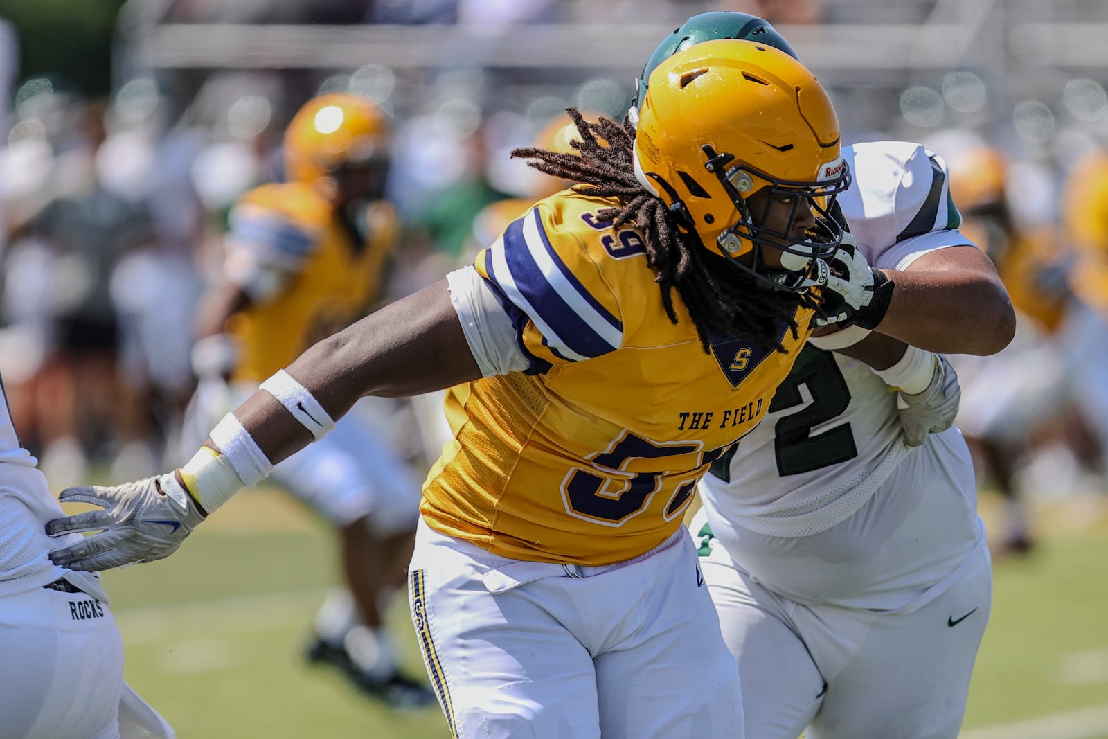 Springfield High School defensive tackle Royce Rogers plows through the interior line of Louisville Trinity during their game earlier this month in Springfield. MICHAEL COOPER / STAFF
