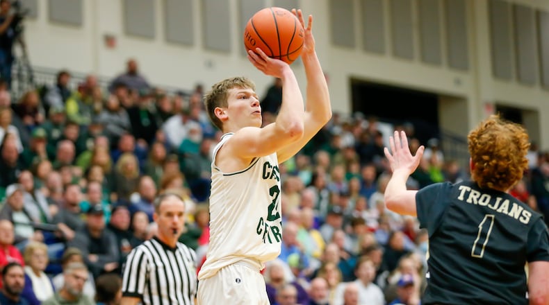 Catholic Central High School senior Ian Galluch shoots the ball over Botkins' Jameson Meyer during their Division IV regional semifinal game on Tuesday night at Kettering’s Trent Arena. Botkins won 60-46. CONTRIBUTED PHOTO BY MICHAEL COOPER