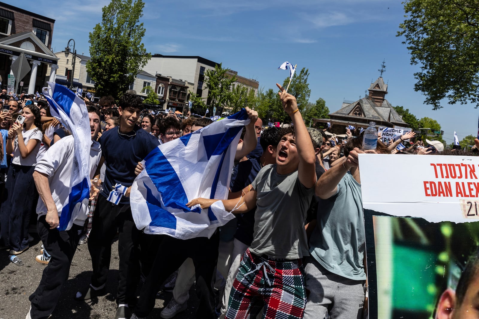 People gathered in Huyler Park celebrate the release of American hostage Edan Alexander from Hamas on Monday, May 12, 2025, in Tenafly, N.J. (AP Photo/Stefan Jeremiah)