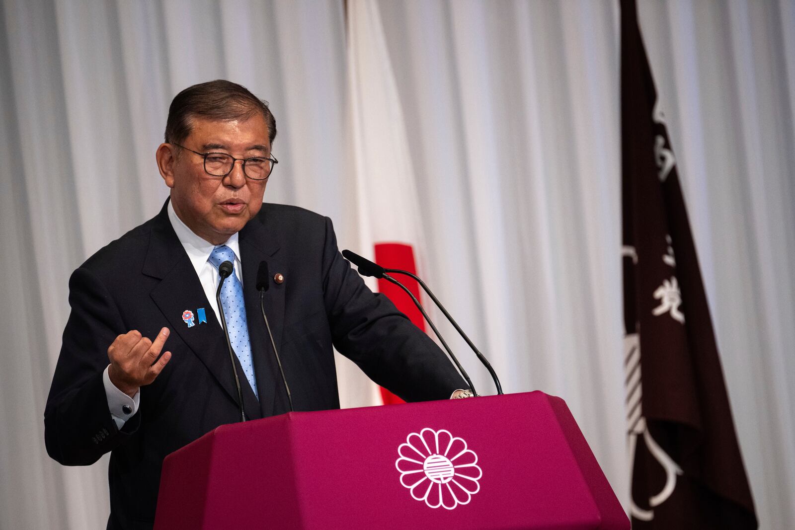 Japan's Prime Minister Shigeru Ishiba attends a press conference at the headquarters of the Liberal Democratic Party (LDP) in Tokyo Monday, July 21, 2025 after the prime minister's ruling coalition failed to secure a majority in the upper house in a parliamentary election. (Philip Fong/Pool Photo via AP)
