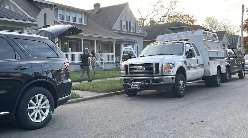 A Springfield Police Division evidence collection unit is shown at the scene of a house in the 200 block of W. Liberty Street. Law enforcement officials were seen Tuesday evening removing boxes of potential evidence, including a computer hard drive. | BILL LACKEY/STAFF
