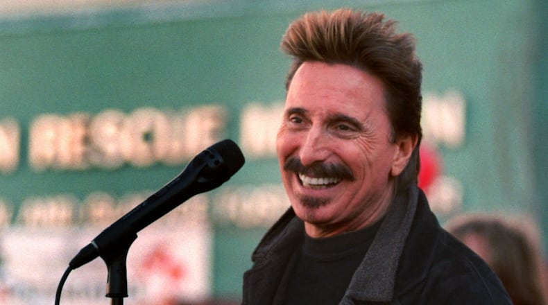 FILE - Chuck Negron, former lead singer of Three Dog Night, sings to a crowd during a Christmas Eve party, Dec. 24, 1997, at the Union Rescue Mission in Los Angeles. (AP Photo/John Hayes, File)